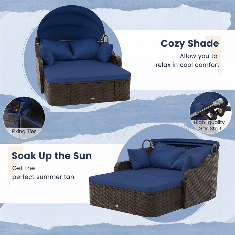 Patio PE rattan daybed with a retractable canopy and soft navy cushions, perfect for relaxing in the garden or by the poolside.