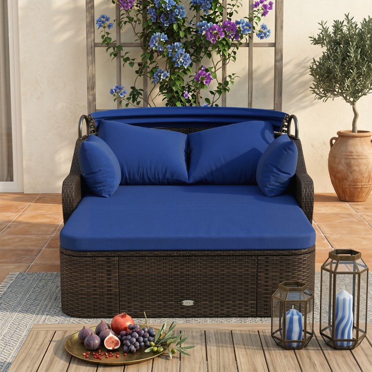 Patio PE rattan daybed in navy with retractable canopy and soft cushions, perfect for lounging by the poolside or garden.