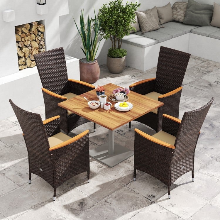 Four outdoor wicker dining chairs with high backrests, featuring beige cushions and acacia wood armrests, ideal for.