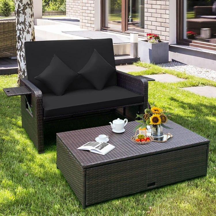 Black patio rattan loveseat with adjustable backrest, soft cushions, and retractable side trays for outdoor relaxation.