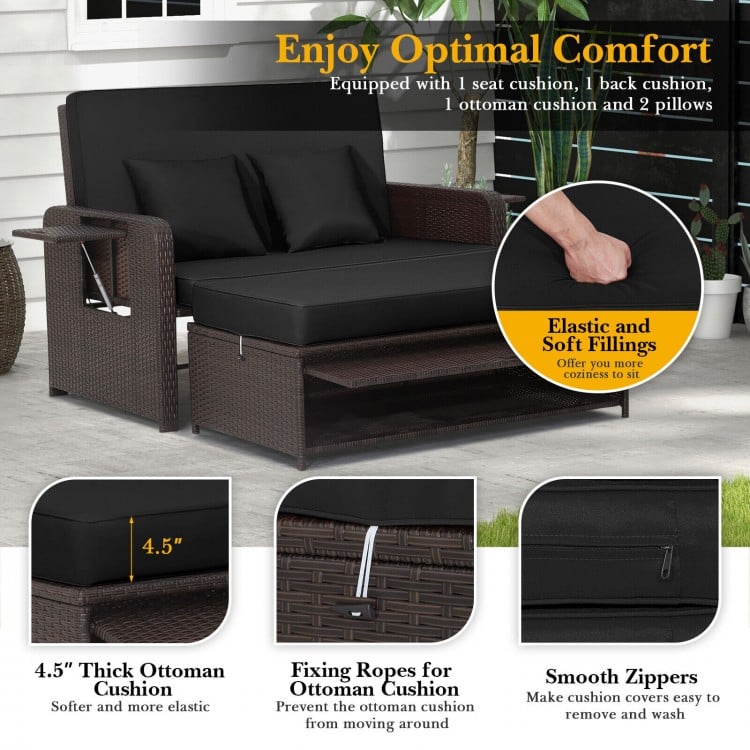 Patio rattan daybed with adjustable backrest, black cushions, and retractable side trays for outdoor relaxation.