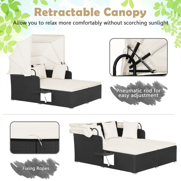 Patio rattan daybed with retractable canopy, off-white cushions, and side tables for comfortable outdoor relaxation.