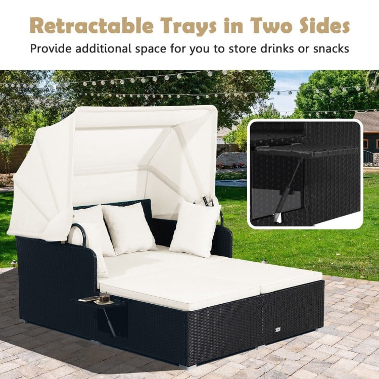 Patio rattan daybed showcasing retractable side trays and soft cushions, designed for convenient outdoor lounging.