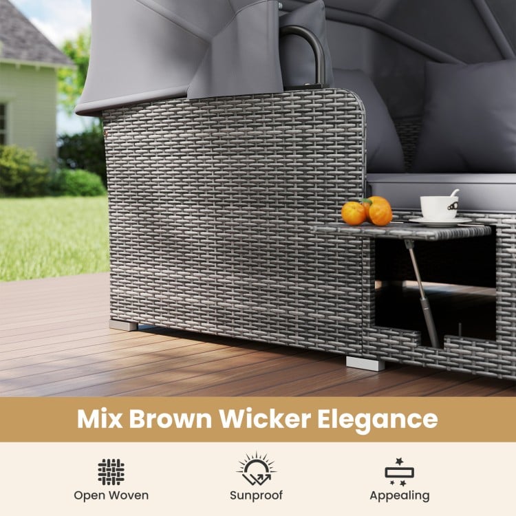 Patio rattan daybed with retractable canopy and side tables in mix brown wicker, perfect for outdoor relaxation.