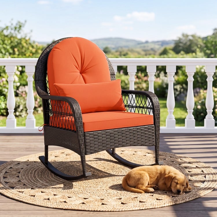 Patio rattan rocking chair with red cushions, featuring ergonomic design and durable PE rattan, perfect for outdoor relaxation.