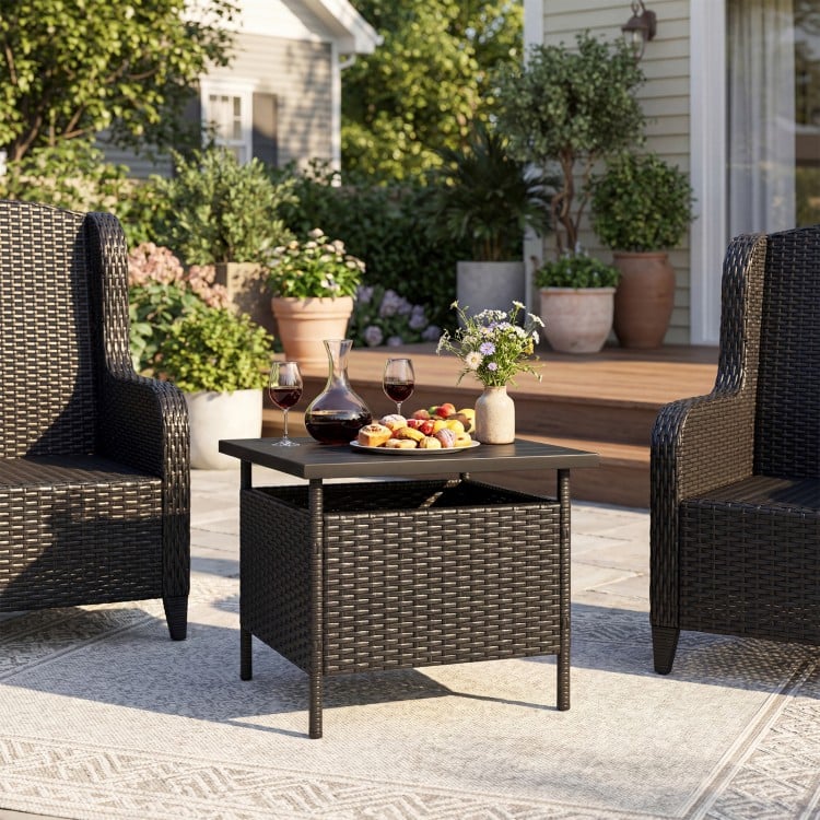 Black patio square wicker side table with umbrella hole, featuring a faux wood top and sturdy rattan frame for outdoor.
