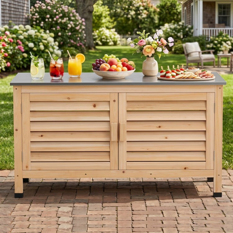 Patio storage cabinet with stainless steel countertop and L-shaped shelf, perfect for organizing tools and tableware outdoors.