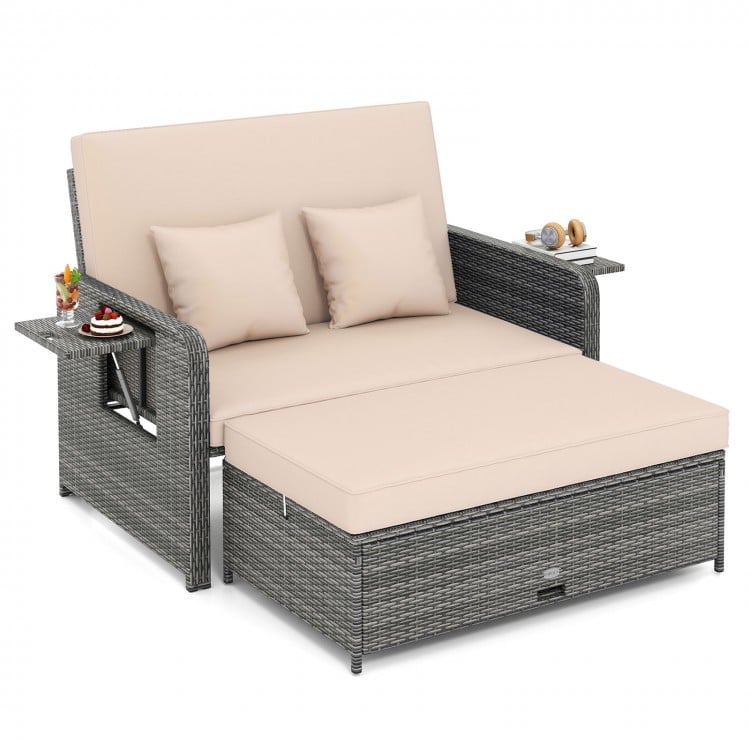 Patio wicker loveseat sofa with beige cushions, adjustable backrest, and retractable side trays for outdoor relaxation.