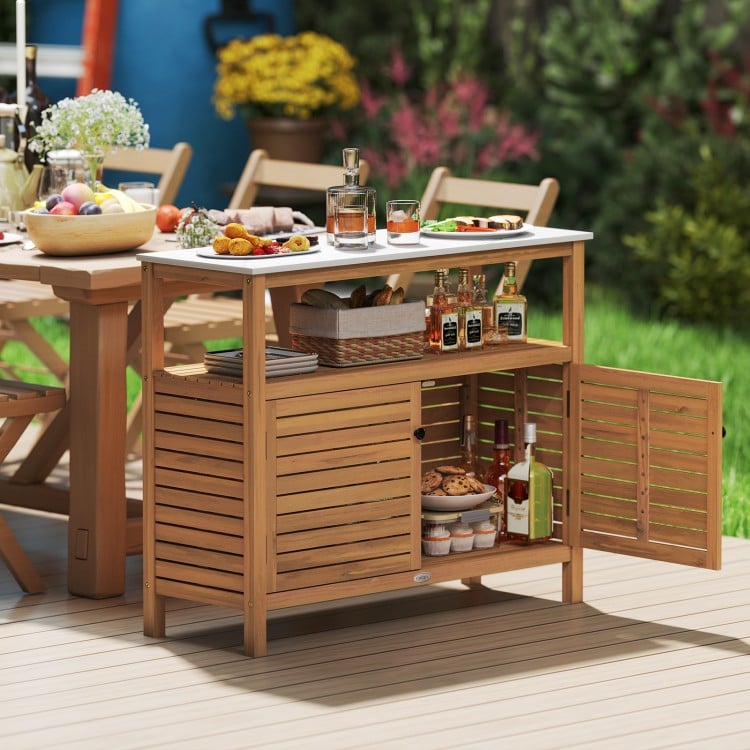 Acacia wood outdoor storage cabinet with marble-like countertop, featuring a spacious shelf and two-door cabinet for.