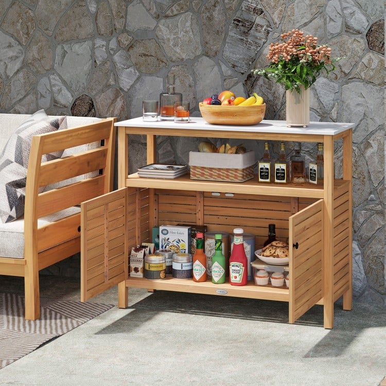 Acacia wood outdoor storage cabinet with marble-like countertop, featuring two doors for versatile organization.