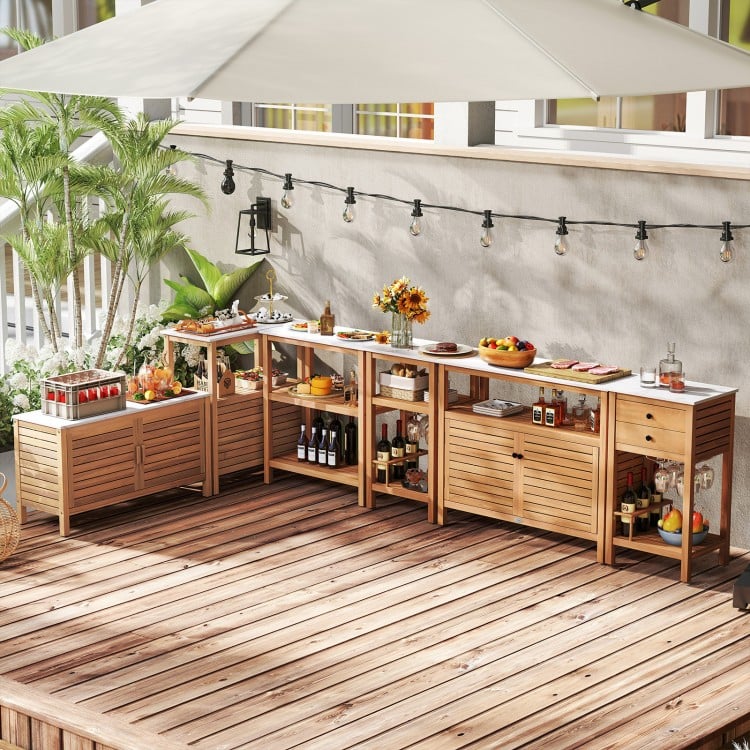 Outdoor acacia wood buffet cabinet with marble-like countertop, ideal for versatile storage in gardens and patios.