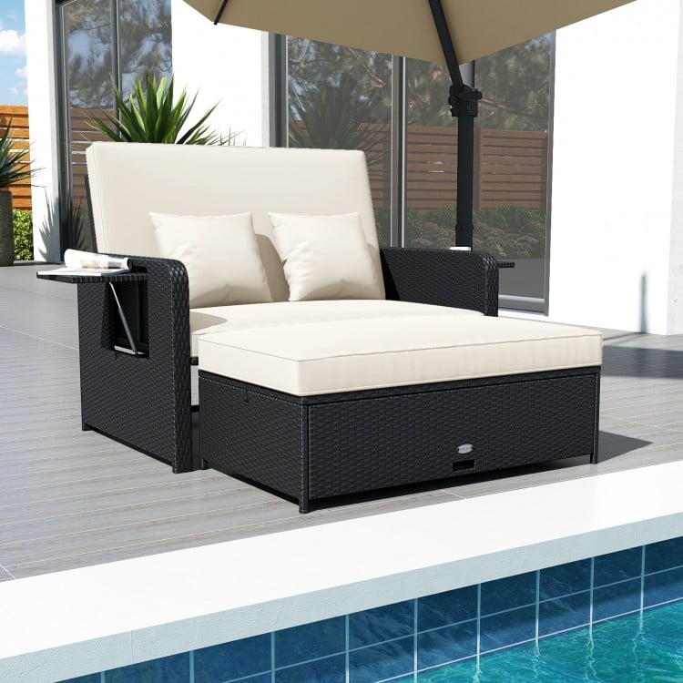 PE wicker outdoor daybed with adjustable backrest and storage ottoman, perfect for patio and poolside relaxation.