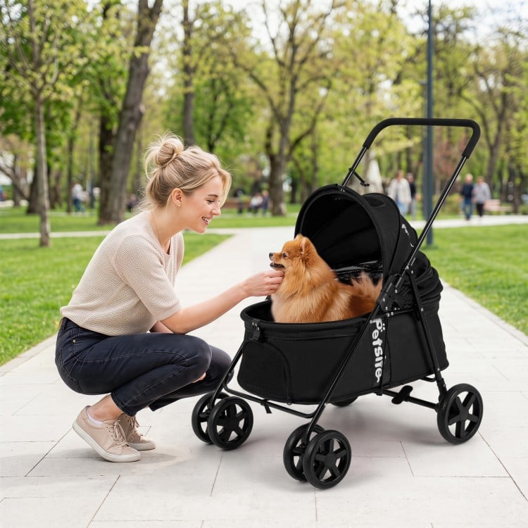 Pet stroller for small to medium dogs in black, shown in use with a happy dog, highlighting its spacious cabin and.