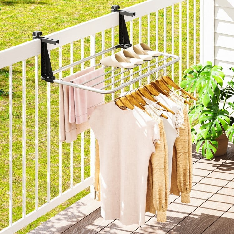 Portable aluminum clothes drying rack with adjustable brackets, featuring 7 bars for hanging items on a balcony railing.