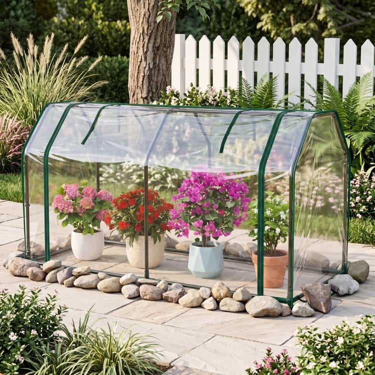 Portable mini greenhouse with PE cover and zippered door, ideal for protecting plants in the backyard or garden.