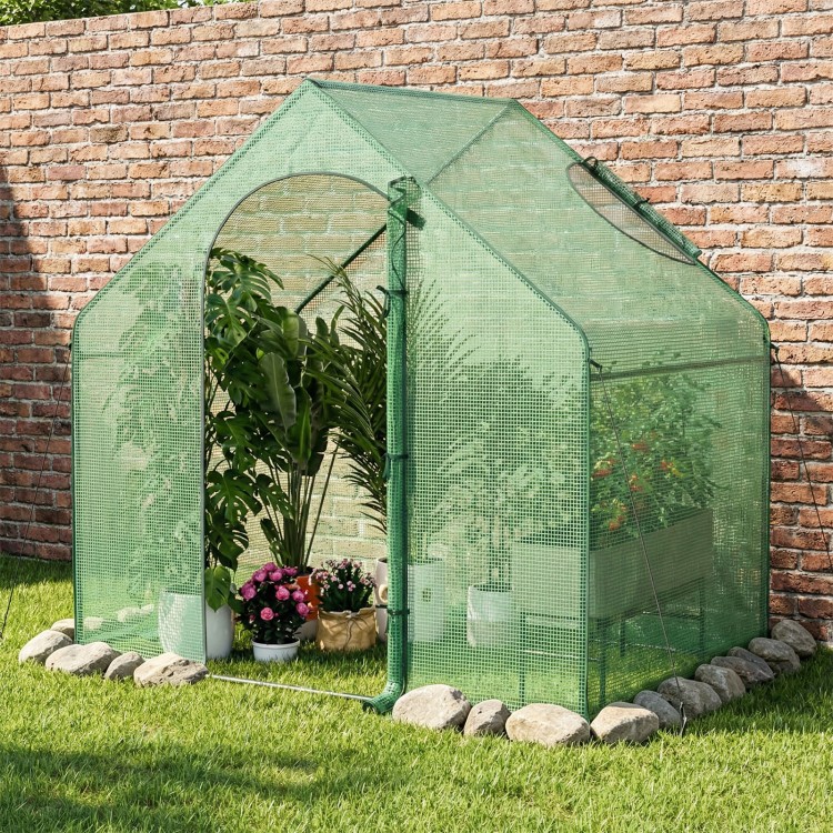 Portable outdoor warm house with PE cover and zippered door, designed for plant protection and easy access.