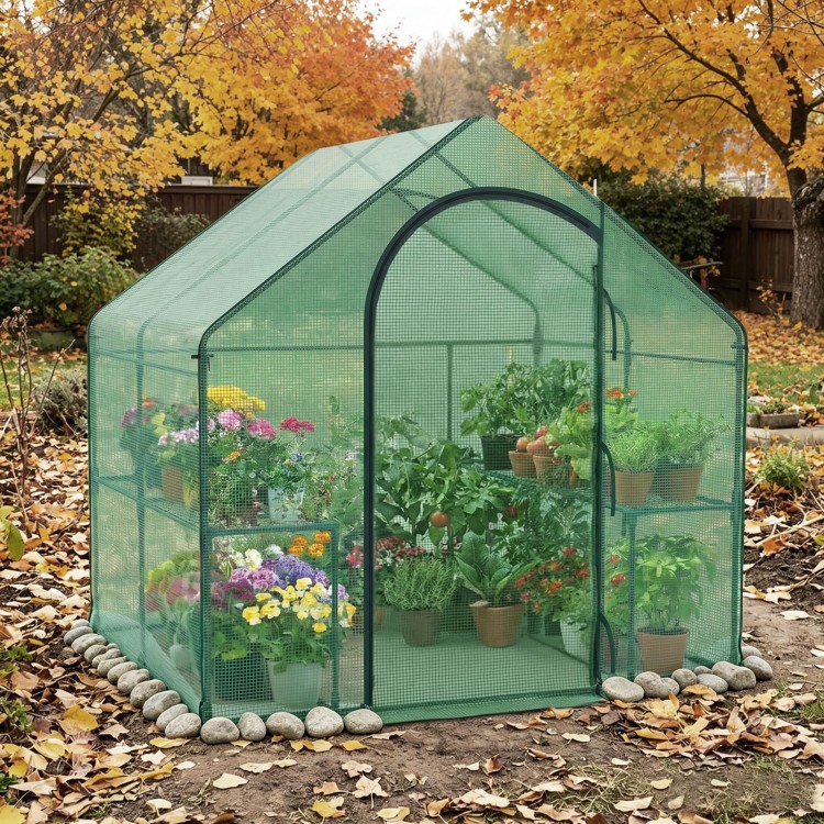 Portable outdoor warm house with PE cover and roll-up zippered door, ideal for protecting plants year-round.
