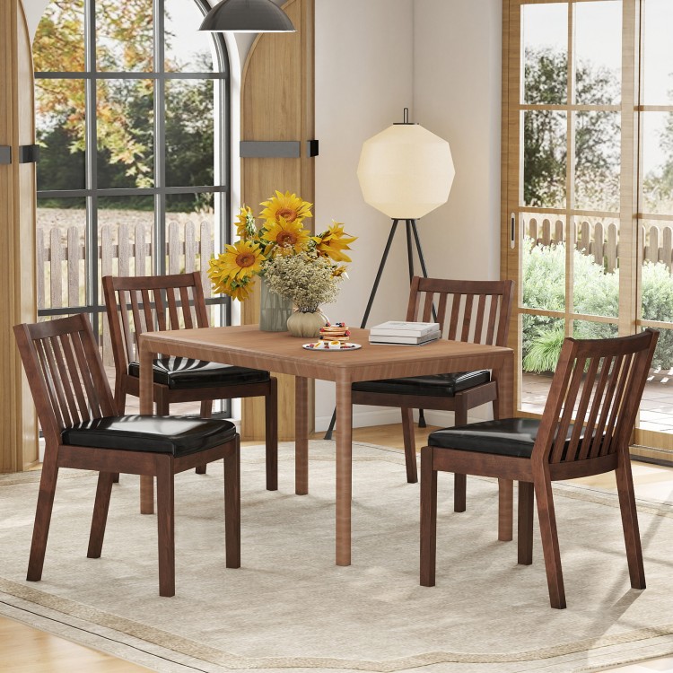 Espresso PU leather upholstered dining chairs with padded seats, set of 4, in a cozy dining room setting.