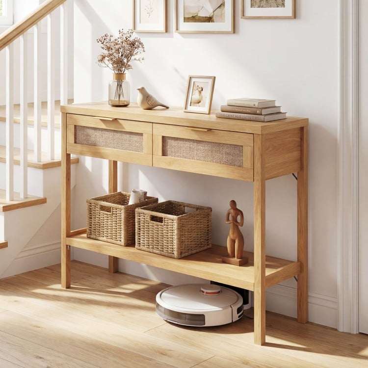 Rattan console table with two drawers and bottom shelf in natural finish, ideal for decorative display and storage.