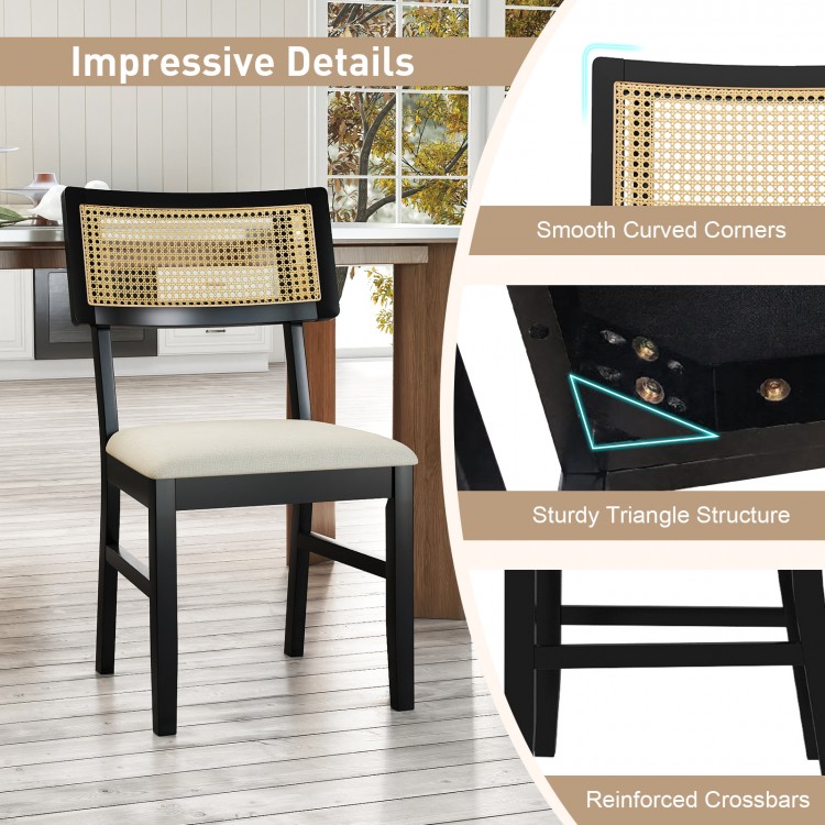 Black rattan dining chair with padded seat, rubber wood legs, and breathable backrest for comfortable kitchen seating.