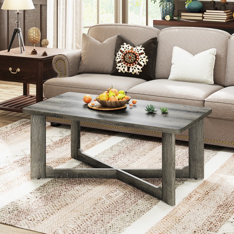 Rectangle coffee table in gray rubber wood with X-shaped base, showcasing rounded corners and metal connectors for.