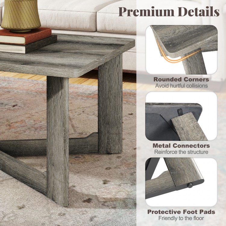 Rectangle coffee table in gray with rounded corners, rubber wood base, and X-shaped design for stability and style.