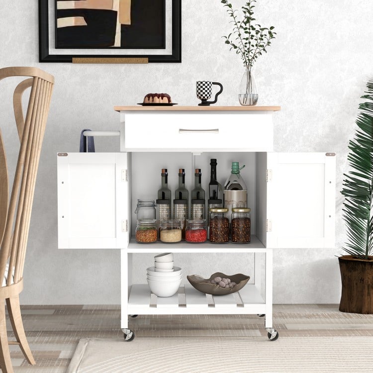 Rolling kitchen island cart in white with rubber wood countertop, pull-out drawer, and storage for kitchen supplies.