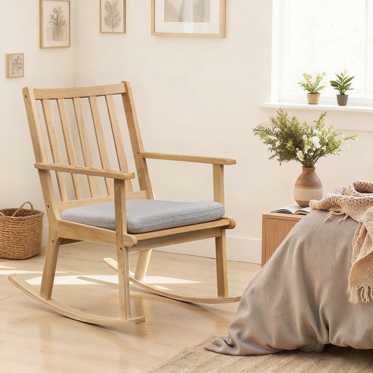 Natural wood rocking chair with padded seat cushion, ergonomic backrest, and rustic charm for relaxing in any room.
