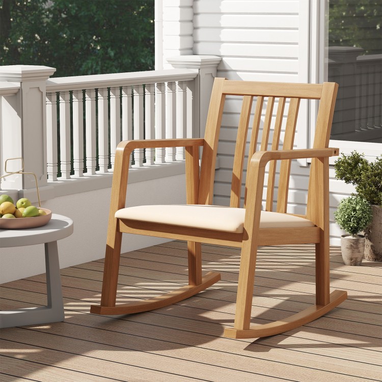Natural rocking chair with slatted back and curved armrests, featuring a comfy linen seat for outdoor relaxation.