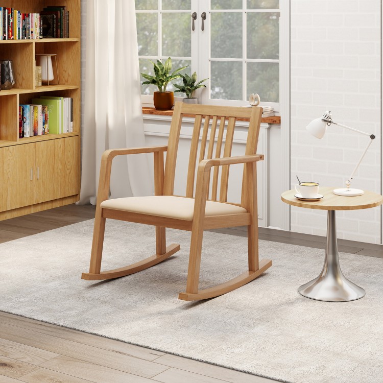 Natural rocking chair with slatted back, curved armrests, and soft linen seat, perfect for relaxing in any room.