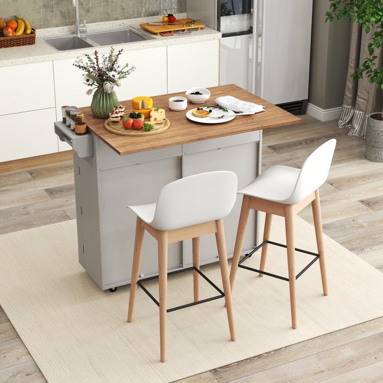 Rolling kitchen island with a drop leaf top, trash cabinet, and two bar stools, perfect for dining and storage.