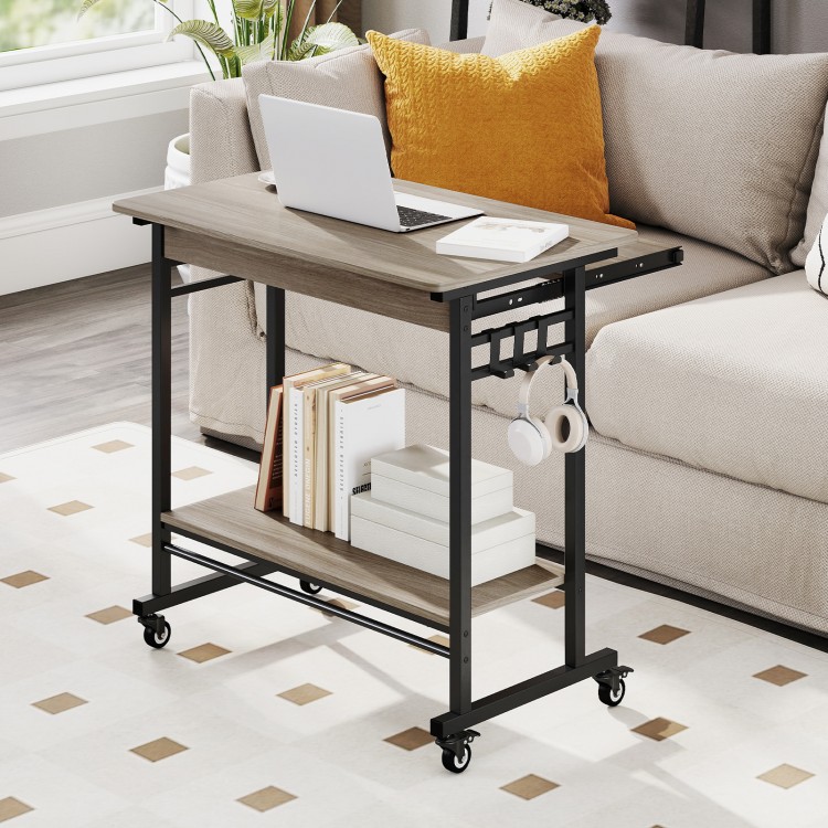 Rolling laptop table in grey with pull-out keyboard tray, hooks, and bottom shelf for convenient workspace organization.