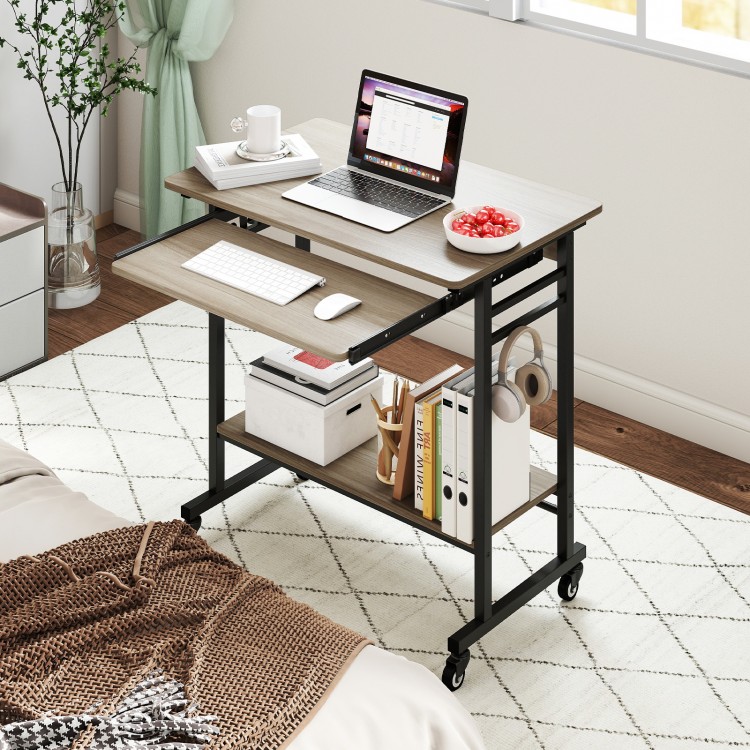 Rolling laptop table in grey with pull-out keyboard tray, hooks, and bottom shelf, ideal for home office use.