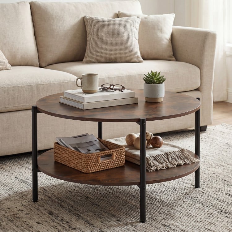 Round coffee table in rustic brown with a spacious surface and a lower shelf for easy access to magazines and snacks.