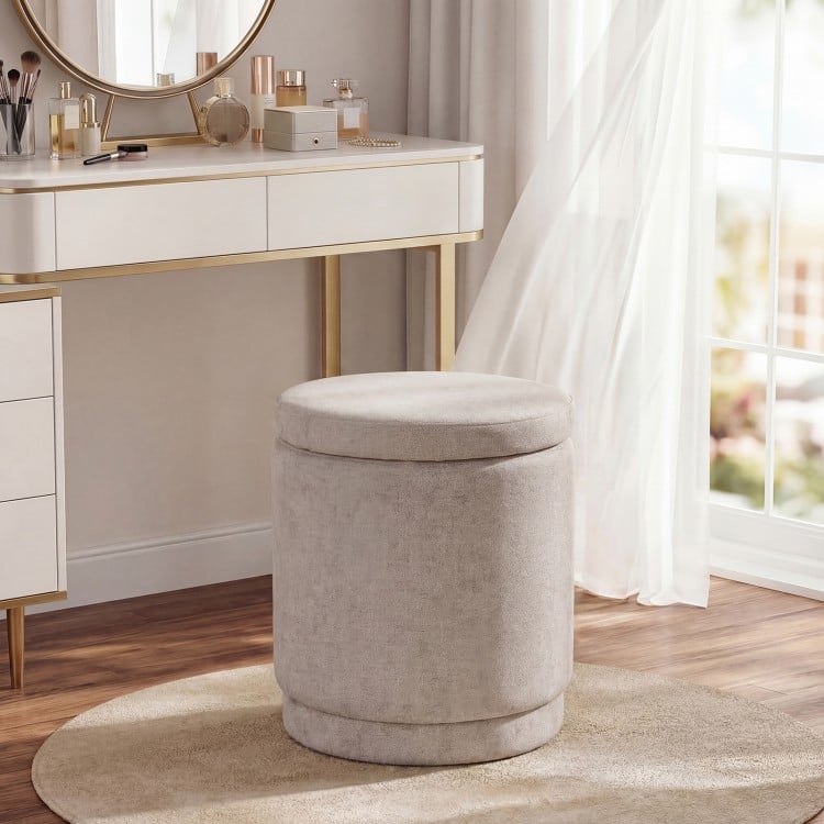 Round beige storage ottoman with removable lid, acacia wood frame, and soft chenille fabric for versatile use.