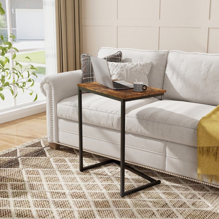 C-shaped industrial end table with a minimalist design, seamlessly fitting beside a sofa for work or snacks.