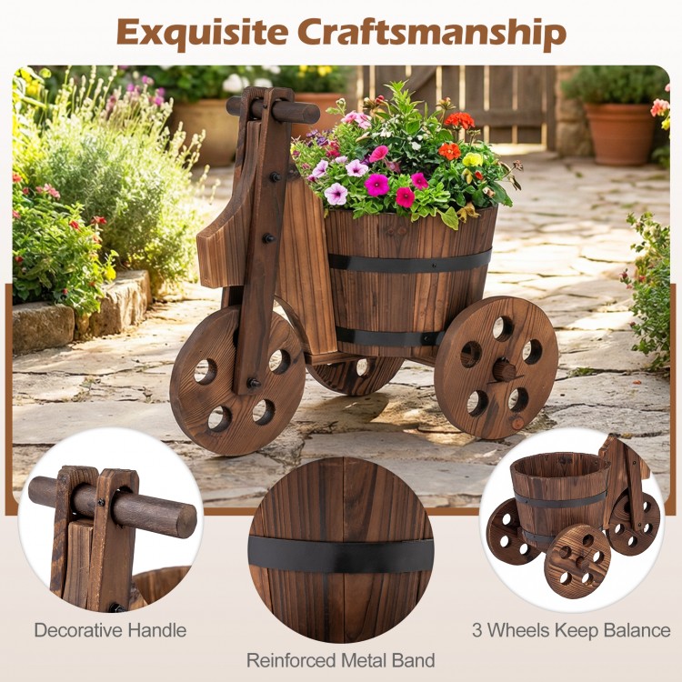Rustic wood tricycle planter barrel with drainage hole, reinforced metal band, and three wheels for stability.