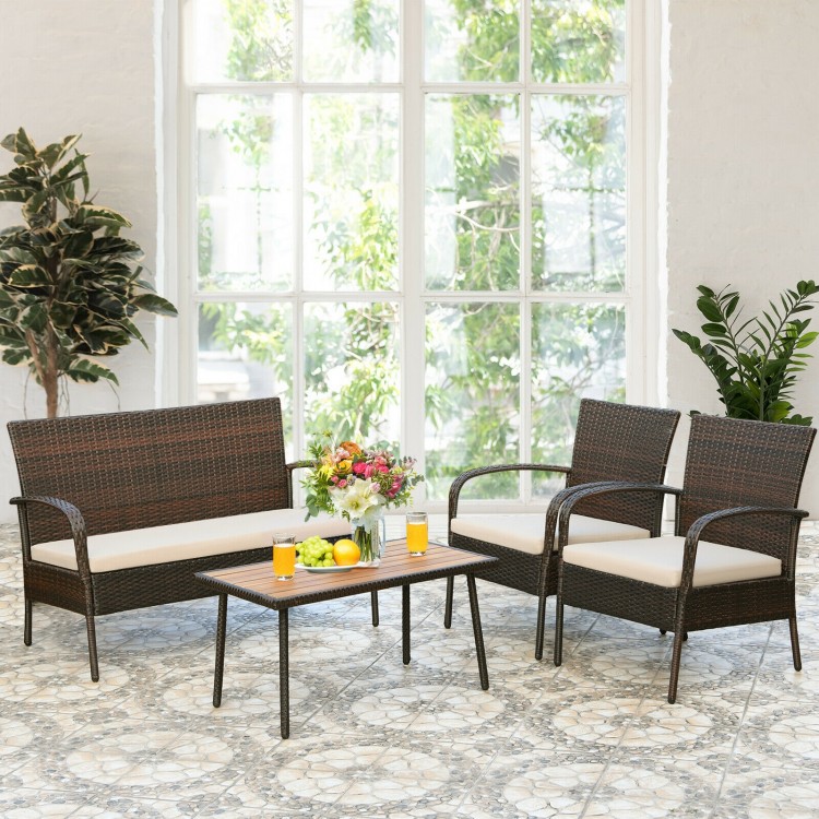 4-piece patio cushioned wicker conversation set with acacia wood tabletop, perfect for indoor and outdoor use.