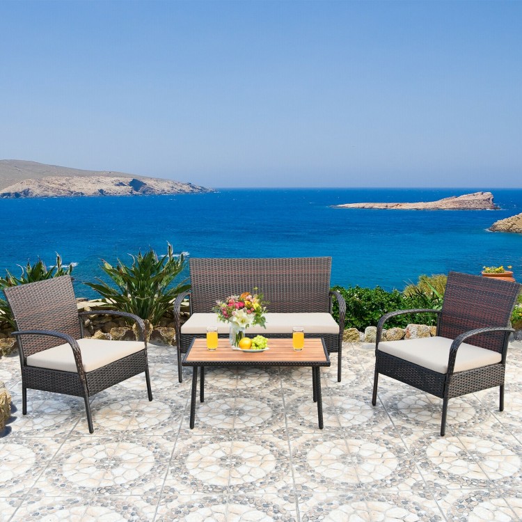4-piece patio cushioned wicker conversation set with acacia wood tabletop, perfect for outdoor relaxation by the sea.