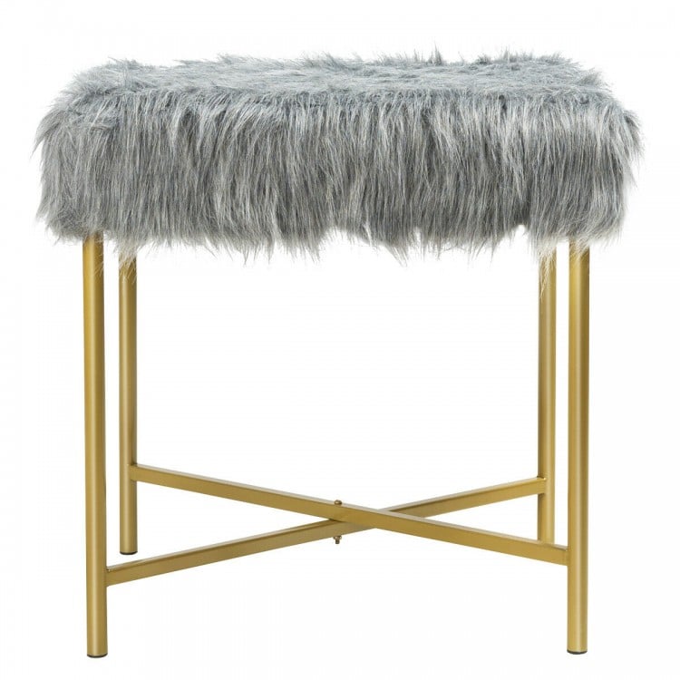 Gray faux fur ottoman stool with golden metal legs, ideal for small spaces and versatile use in any room.