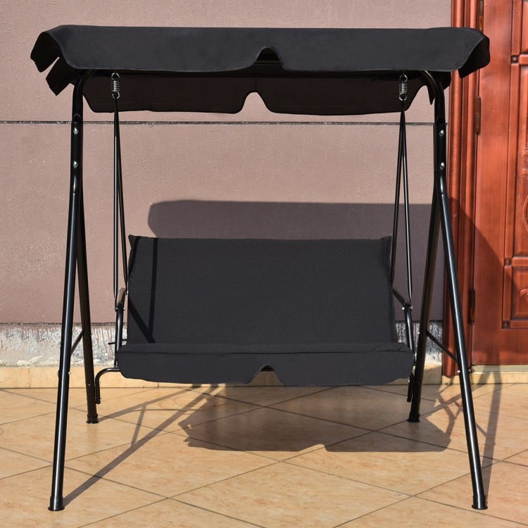 Cushioned black loveseat swing glider with steel frame and canopy, perfect for outdoor relaxation in garden or patio.