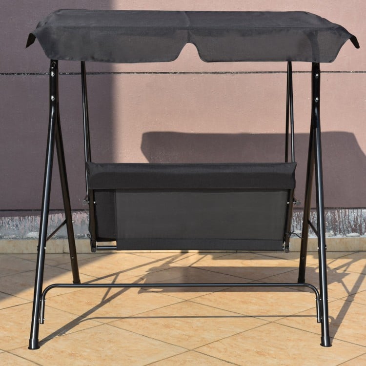 Cushioned black loveseat swing glider with steel frame and canopy, ideal for outdoor relaxation in gardens or patios.