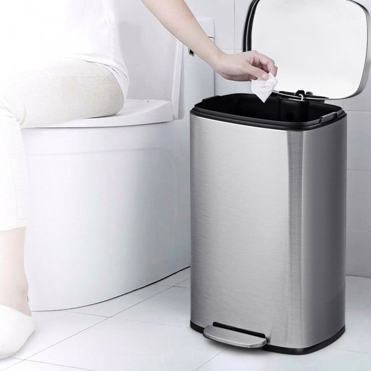 Stainless steel 13.2-gallon trash can with a plastic bucket, pedal operation, and noiseless lid for bathroom use.