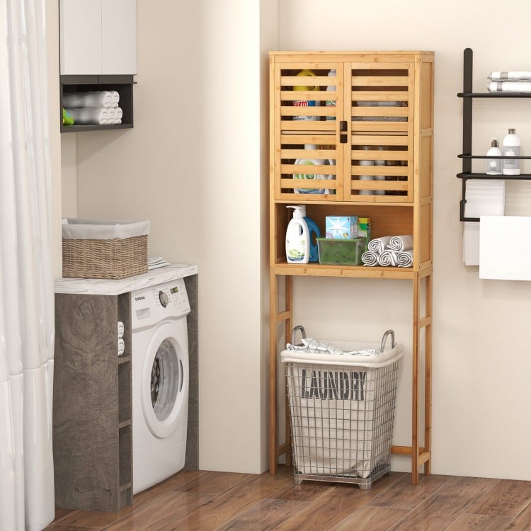 Bamboo over-the-toilet storage cabinet with adjustable shelf, featuring double louvered doors for bathroom organization.