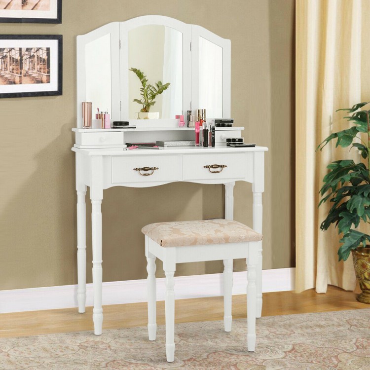 White vanity set with tri-fold mirror, four drawers, and cushioned stool, perfect for bedroom makeup organization.