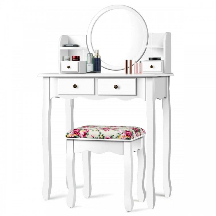 Makeup vanity table set in white with oval mirror, 4 drawers, and cushioned floral stool for stylish dressing.