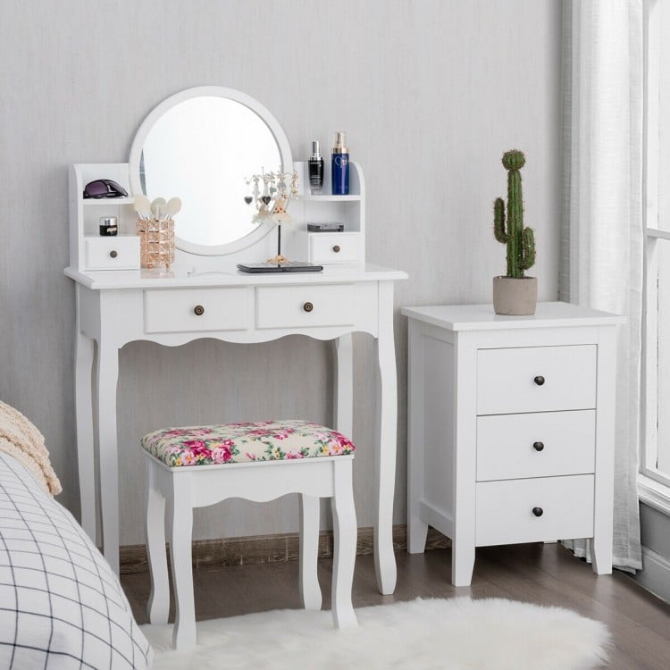 Makeup vanity table set with oval mirror, 4 drawers, and cushioned stool in white for stylish dressing and storage.