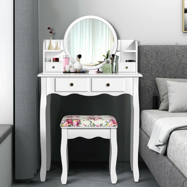White makeup vanity table set with oval mirror, 4 drawers, and cushioned stool for stylish and functional dressing.