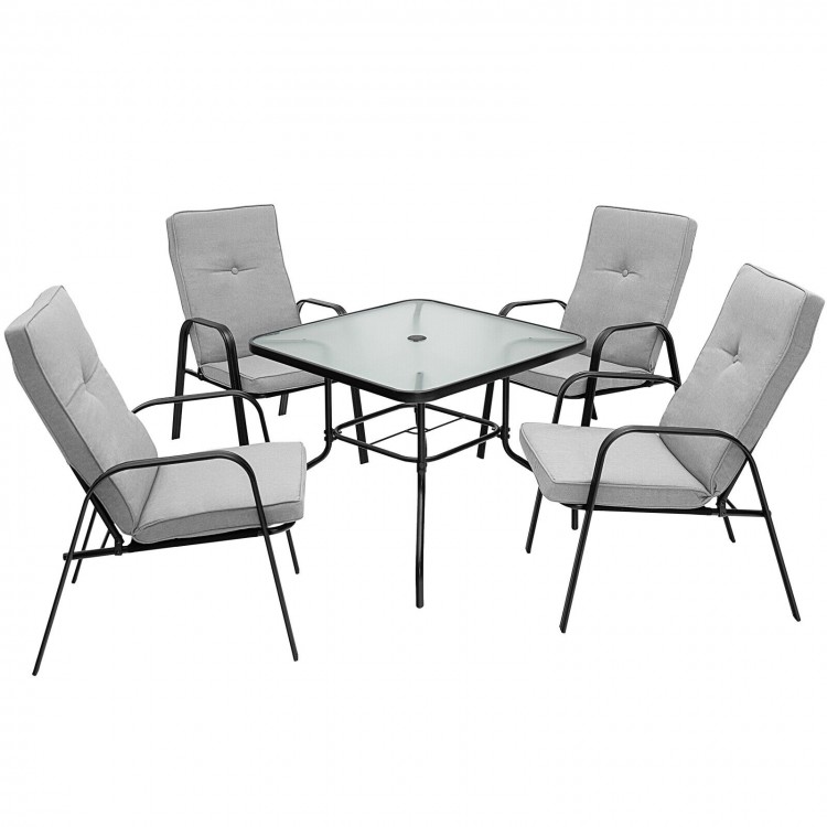 Four stackable patio dining chairs with high-back cushions and a glass table, perfect for outdoor relaxation.