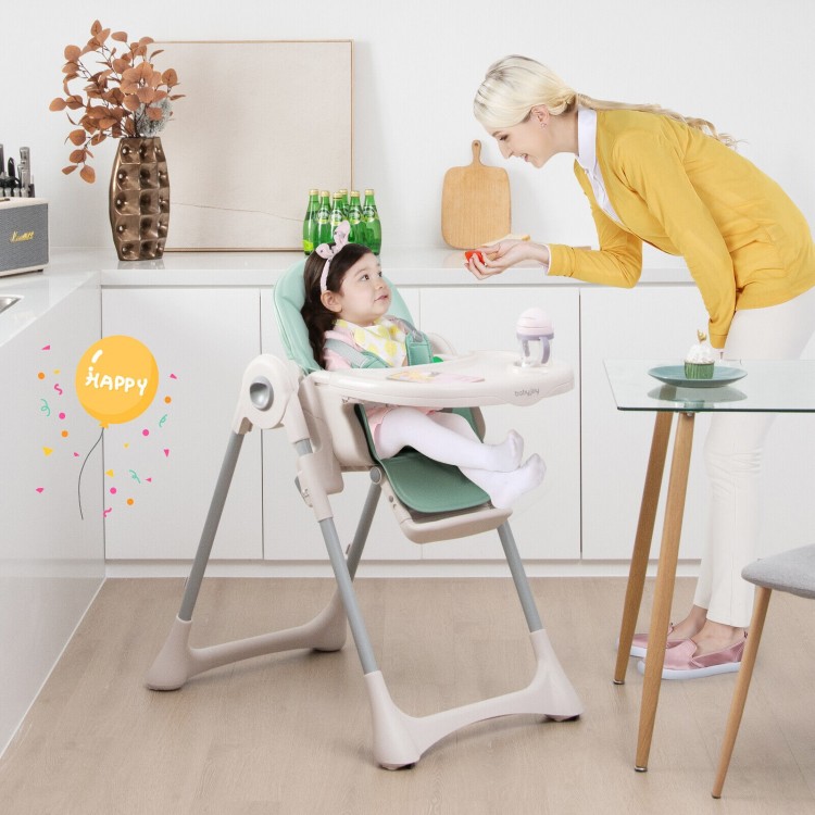 Baby folding high chair in green with adjustable height and footrest, perfect for dining in narrow spaces.